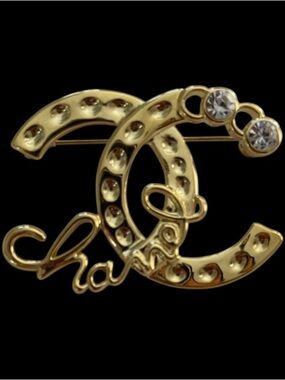 ChaneI. Gold-Tone Spellout- Out Crystal Embellished Brooch